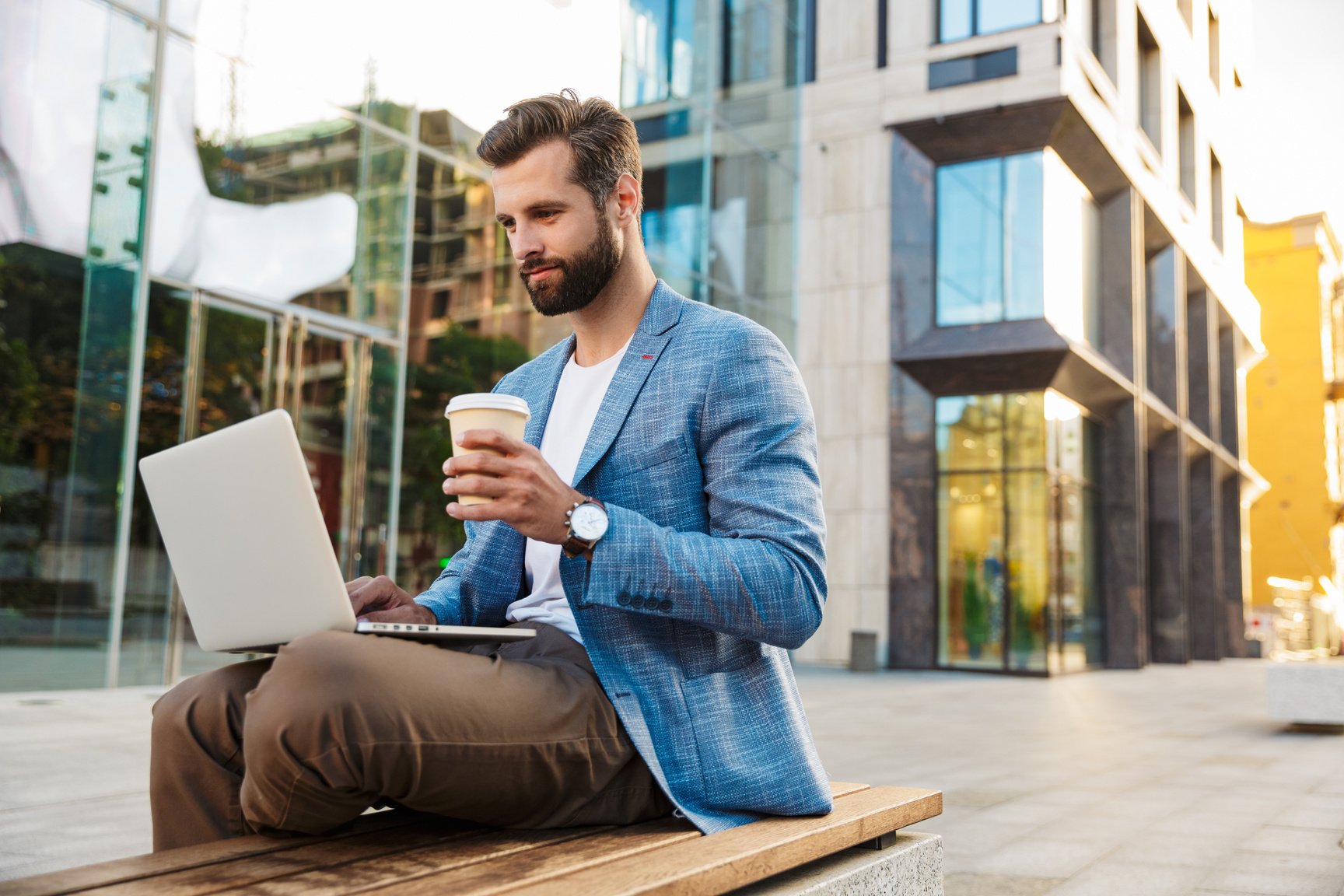 Attractive Young Bussiness Man Working on Laptop